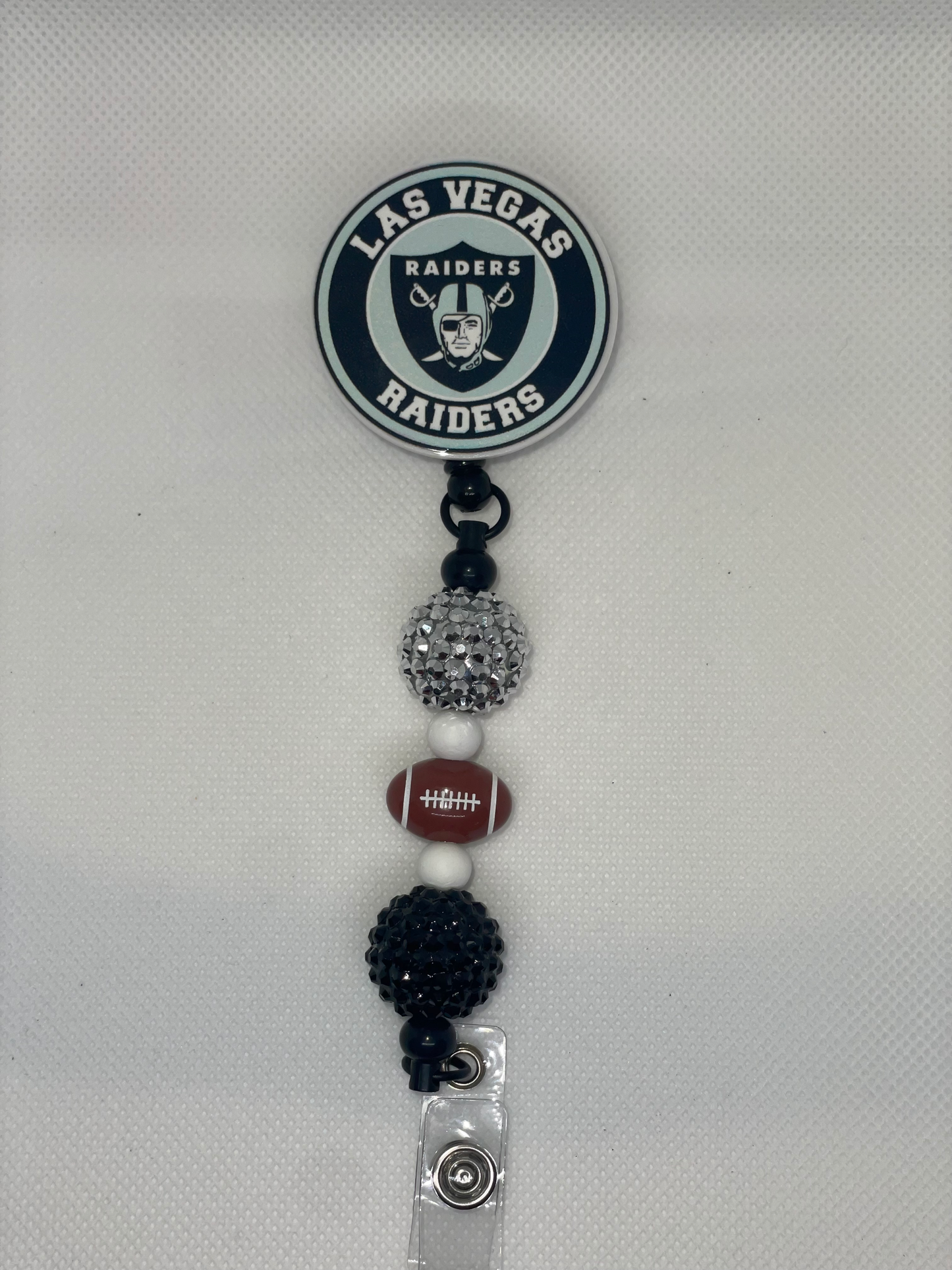 V Raiders football badge reel